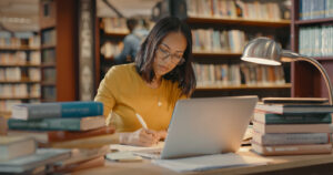 Student researching what happens if you lose your college diploma in library